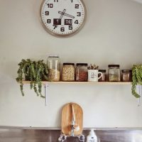 metal clock in the bedroom in high-tech style photo