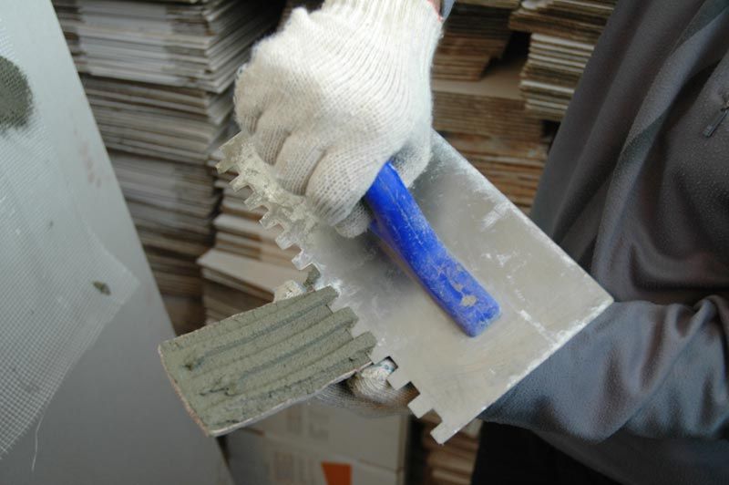 Application of adhesive to decorative stone