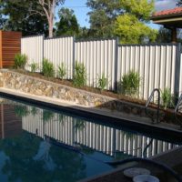 Profiled sheet fence on the slope of a suburban area