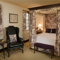 Colorful textile in the design of a classic bedroom