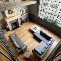 Top view of living room with parquet floor and leather furniture.