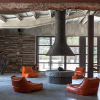 A fireplace in the center of the loft style living room