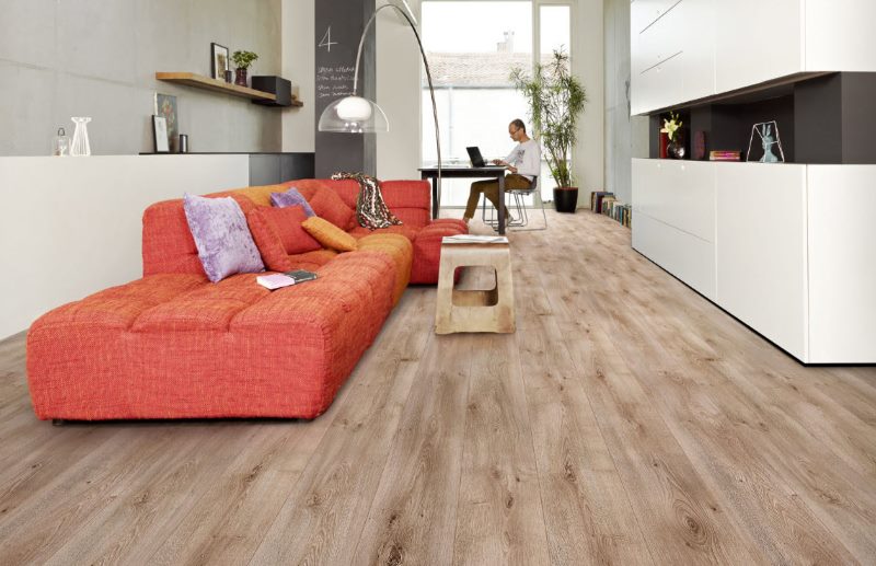 Red sofa on the laminate floor