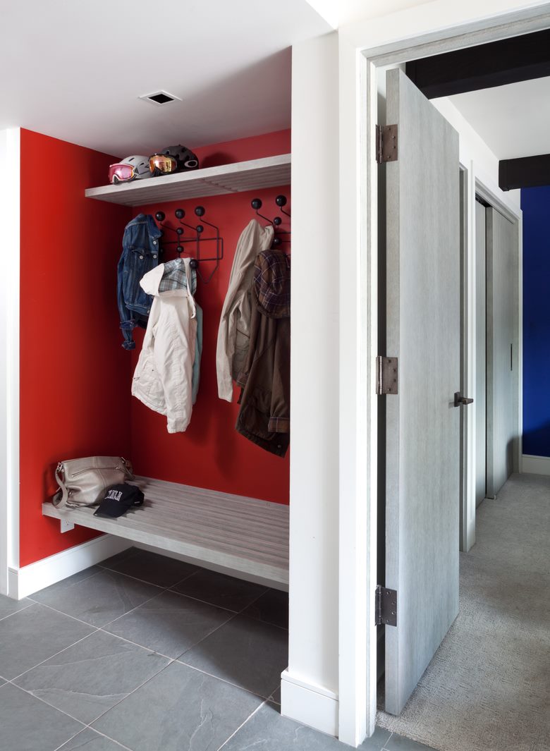 A hanger with a bench deep in the niche of a small corridor