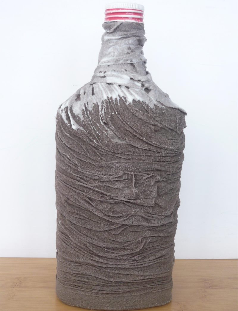 Glue coating PVA tights on a glass bottle