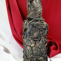 Decorative bottle on a background of red material